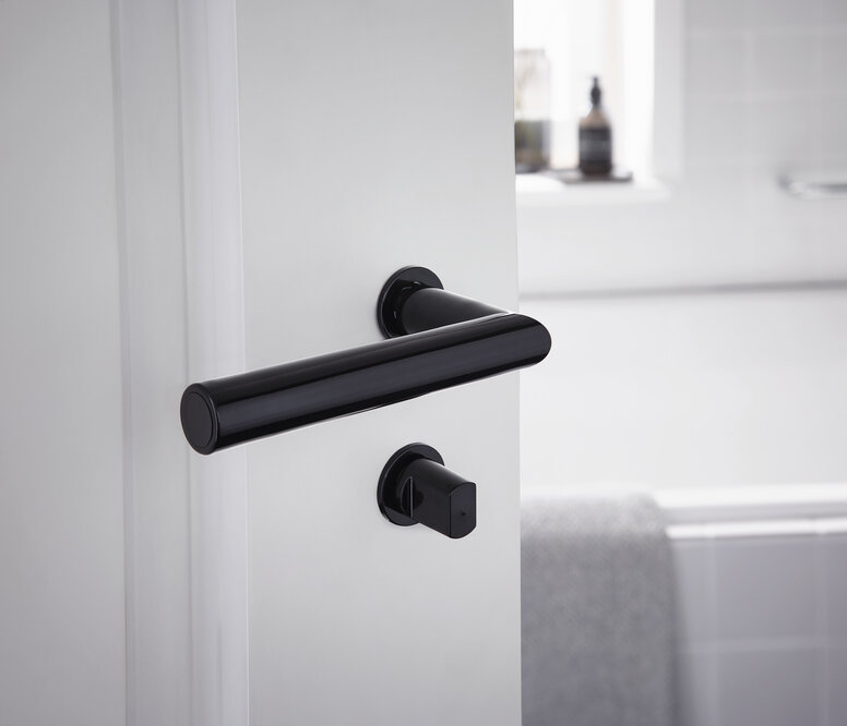 Minimalist door handle with free-mounted rosette in the colour black made of polyamide